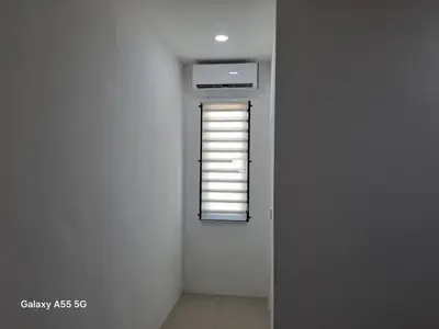 a room with a window in a white wall at Classic Home Stay in Kuala Ketil