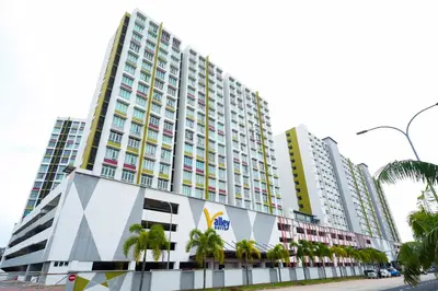 a tall building with palm trees in front of it at Mahkota Valley Suites Kuantan by Iconique in Gua Sai