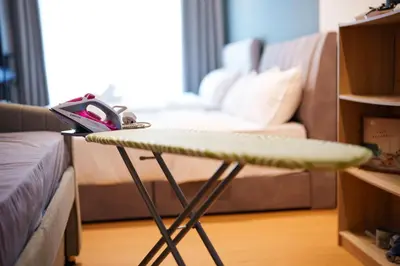 a table with a surfboard on it in a living room at Mahkota Valley Suites Kuantan by Iconique in Gua Sai