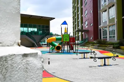 a playground with a slide in the middle of a building at Mahkota Valley Suites Kuantan by Iconique in Gua Sai