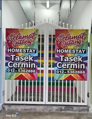 a white gate with two signs on it at Tasek Cermin Roomstay in Ipoh