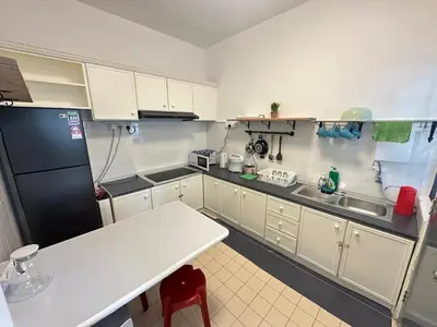 a kitchen with white cabinets and a black refrigerator at Fraser's Haven SilverparkResort Walk down 8 steps in Bukit Fraser