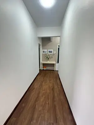 an empty hallway with white walls and wood floors at Fraser's Haven SilverparkResort Walk down 8 steps in Bukit Fraser