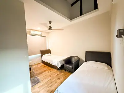a room with two beds and a chair in it at ComfortCottage Ipoh Coliving & Whole Unit in Ipoh