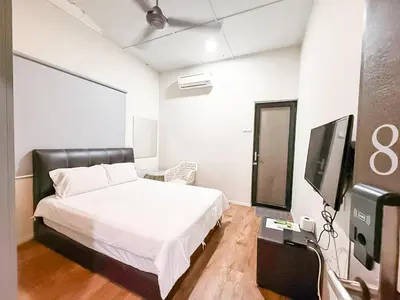 a bedroom with a bed and a flat screen tv at ComfortCottage Ipoh Coliving & Whole Unit in Ipoh