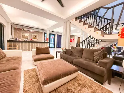a living room with two couches and a staircase at ComfortCottage Ipoh Coliving & Whole Unit in Ipoh