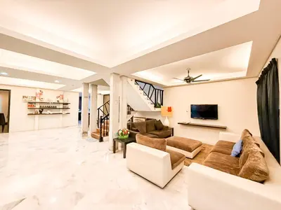a living room with a couch and a tv at ComfortCottage Ipoh Coliving & Whole Unit in Ipoh