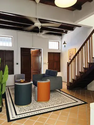 a living room with a couch and a table at Courtyard by Heritage Row in George Town