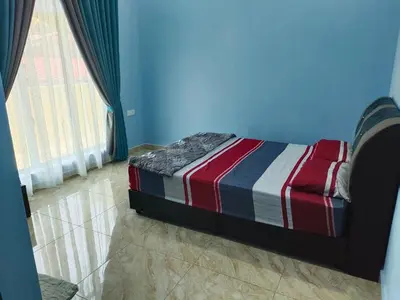 a bedroom with a bed in a blue room at SUN HOMESTAY Teluk Intan
