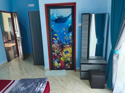 a room with a fish tank in the wall at SUN HOMESTAY Teluk Intan