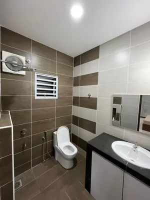 a bathroom with a toilet and a sink at KK Homestay Ipoh in Ipoh