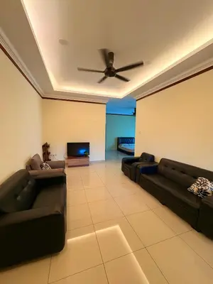 a living room with couches and a ceiling fan at KK Homestay Ipoh in Ipoh