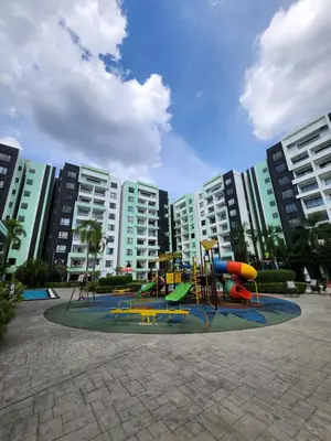 a playground in a park in front of some buildings at Manhattan Condominium Ipoh in Ipoh