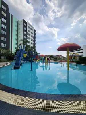 a swimming pool with a slide and an umbrella at Manhattan Condominium Ipoh in Ipoh