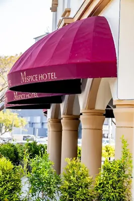 a purple umbrella on the side of a building at M Spice Hotel Seberang Jaya in Perai