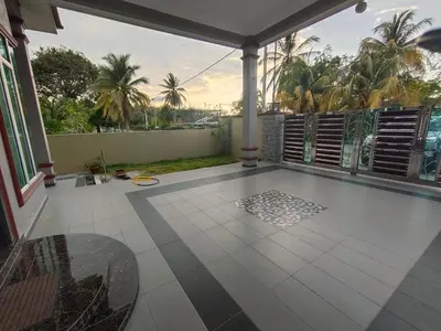 a balcony with a view of a patio with palm trees at SUN HOMESTAY Teluk Intan
