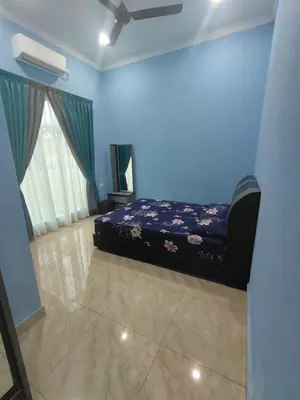 a blue room with a bed and a window at SUN HOMESTAY Teluk Intan