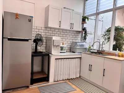 a kitchen with white cabinets and a refrigerator at Corner Single-Storey Fire Camp 9pax FreeWiFi Ipoh Town By LUX SUITES in Ipoh