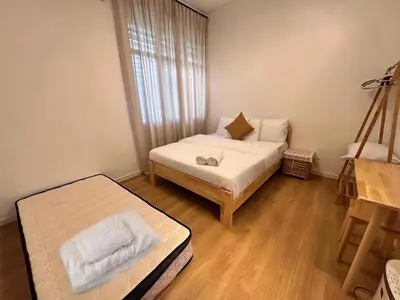 a small room with a bed and a couch at Corner Single-Storey Fire Camp 9pax FreeWiFi Ipoh Town By LUX SUITES in Ipoh