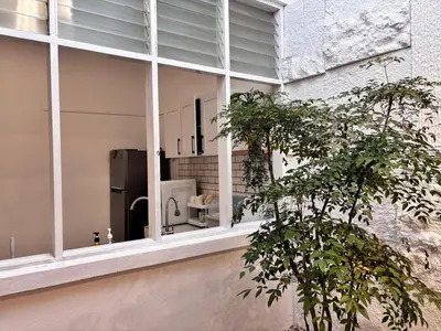 a building with a window with a refrigerator in it at Corner Single-Storey Fire Camp 9pax FreeWiFi Ipoh Town By LUX SUITES in Ipoh