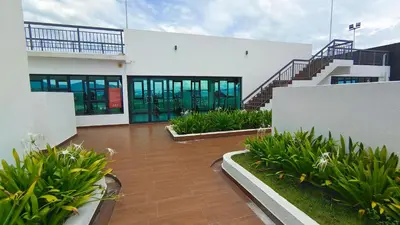 a large white building with glass doors and plants at Horizon Skyline Loft in Ipoh