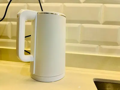 a white mug sitting on top of a counter at Breathtaking Sea View Penang Bridge 2BR in Bayan Lepas