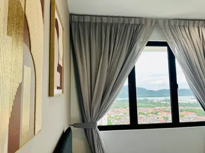 a room with a window with curtains and a view at Breathtaking Sea View Penang Bridge 2BR in Bayan Lepas