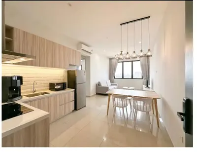 a kitchen with a table and chairs in a room at Luxury Sky Stay Sea & Penang Bridge View in Bayan Lepas