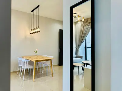 a dining room and kitchen with a table and a mirror at Luxury Sky Stay Sea & Penang Bridge View in Bayan Lepas