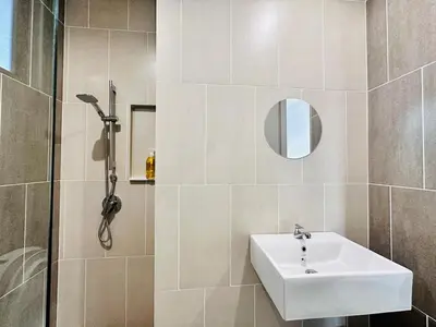 a bathroom with a sink and a shower at Luxury Sky Stay Sea & Penang Bridge View in Bayan Lepas