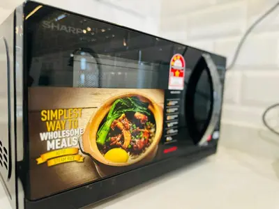 a microwave oven with a picture of a soup in it at Romantic Sea & Penang Bridge View Luxury 2BR in Bayan Lepas