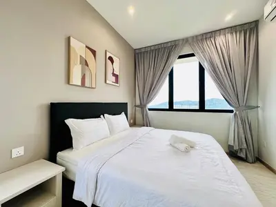 a bedroom with a white bed and a window at High Floor Sea View Penang Bridge Luxury 2BR in Bayan Lepas
