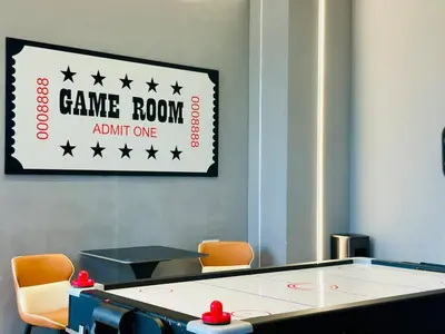 a game room with a ping pong table and a sign at WOW! Sea & Penang Bridge View Infinity Pool 2BR in Bayan Lepas