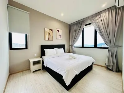 a bedroom with a large bed and two windows at WOW! Sea & Penang Bridge View Infinity Pool 2BR in Bayan Lepas