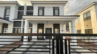 a house with a black fence in front of it at Villa Natura ByTheNook in Sungai Petani