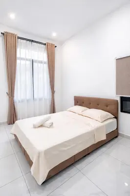 a white bedroom with a large bed and a window at Villa Natura ByTheNook in Sungai Petani