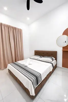 a bedroom with a bed with a black and white blanket at Villa Natura ByTheNook in Sungai Petani