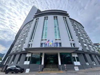 a building with a car parked in front of it at Stallions Suite Penang in Jelutong