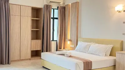 a bedroom with a bed and a window at Stallions Suite Penang in Jelutong