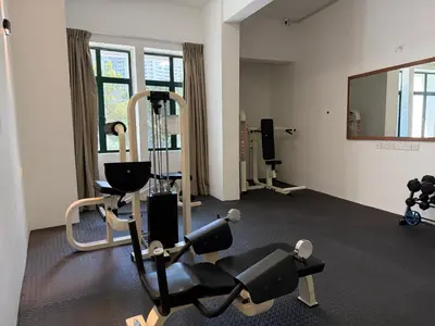 a gym with tread machines and a mirror at Stallions Suite Penang in Jelutong