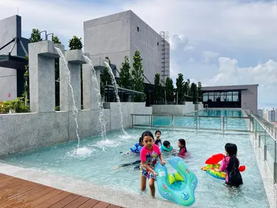 a group of children playing in a swimming pool at Luxury 2BR Rooftop Infinity Pool 8 Pax airport usm in Bayan Lepas