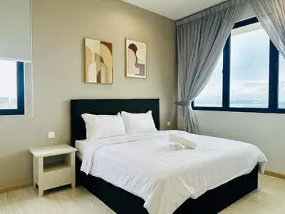 a bedroom with a large bed and two windows at Luxury 2BR Rooftop Infinity Pool 8 Pax airport usm in Bayan Lepas