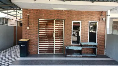 a brick wall with a bench and a trash can at Homestay Kak Su Seri Iskandar in Seri Iskandar