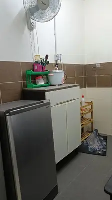 a kitchen with a refrigerator and a fan at Homestay Kak Su Seri Iskandar in Seri Iskandar