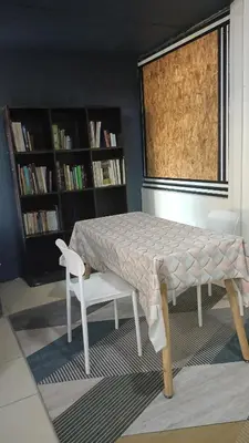 a table and a chair in a room with a window at Homestay Kak Su Seri Iskandar in Seri Iskandar
