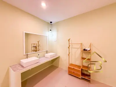 a bathroom with two sinks and a mirror at Ipoh Indoor Pool Homestay, BBQ Mahjong, 16 pax 4BR in Ipoh