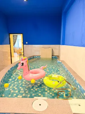 a swimming pool with a toy duck and a toy car at Ipoh Indoor Pool Homestay, BBQ Mahjong, 16 pax 4BR in Ipoh