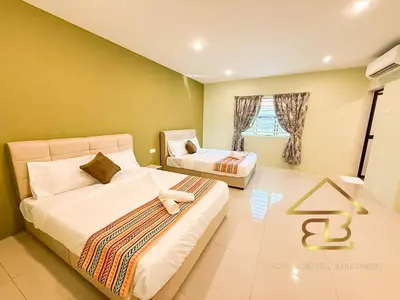 a bedroom with two beds and a window at Ipoh Indoor Pool Homestay, BBQ Mahjong, 16 pax 4BR in Ipoh