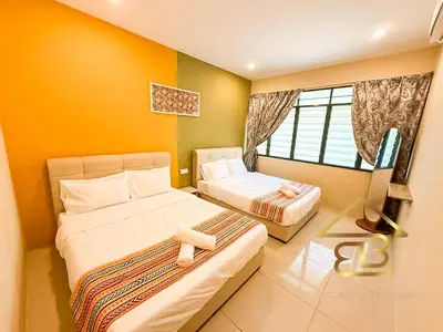a bedroom with two beds and a tv in it at Ipoh Indoor Pool Homestay, BBQ Mahjong, 16 pax 4BR in Ipoh