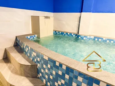 a swimming pool with a blue and white at Ipoh Indoor Pool Homestay, BBQ Mahjong, 16 pax 4BR in Ipoh